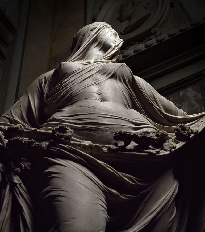 Veiled marble sculpture of a draped figure emerging from carved stone, a masterwork of the veiled-marble tradition